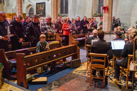 Carol singing filled a Norfolk church to celebrate the bicentenary of the charity that saves lives at sea